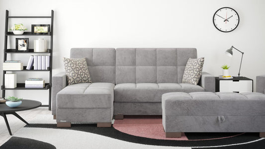 Grey Armada Chaise Lounge sofa bed with storage in a cozy living room, front-facing view.